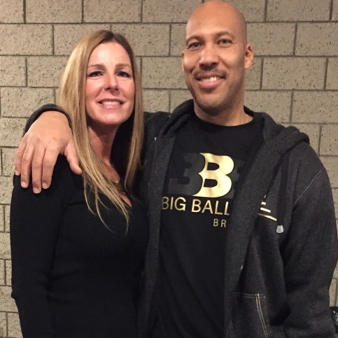 Tina Ball posing in a black dress with her husband LaVar Ball.
